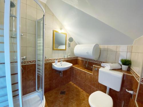 a bathroom with a sink and a toilet and a shower at Apartments Sandra in the historical center of the city in Supetar