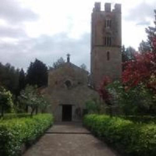 an old stone building with a tower in a garden at Locazione Turistica Arcobaleno "Family Loft" in Roccavivara