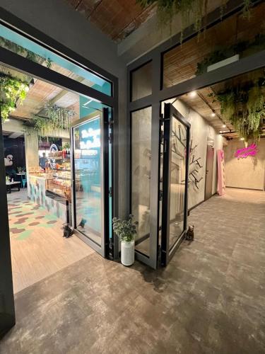 a store front with glass doors and a potted plant at Global Home - Aparthotel - No Contact Check In in Mielec