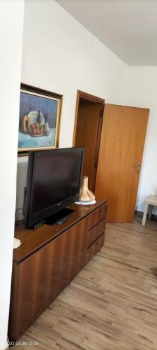 a flat screen tv sitting on top of a dresser at L'incanto home in Bologna