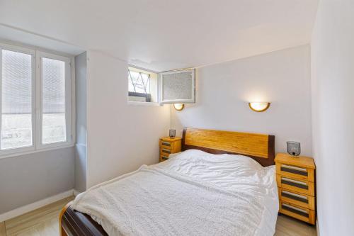 une chambre blanche avec un lit et une fenêtre dans l'établissement Le Doolie's Hostel B&B - El Nido - Jardin - Wifi - VOD, à Biarritz