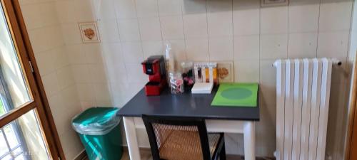 a small black table in a room with a chair at L'incanto home in Bologna