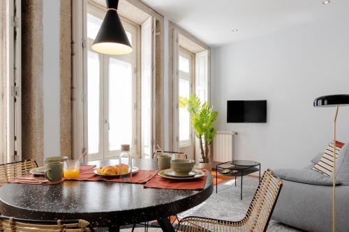 a living room with a table with food on it at Impar luxury residence in Porto