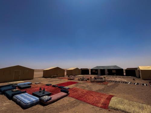 a group of tents in the middle of the desert at Bivouac Les Nomades & Foum zguid to chegaga tours in Foum Zguid