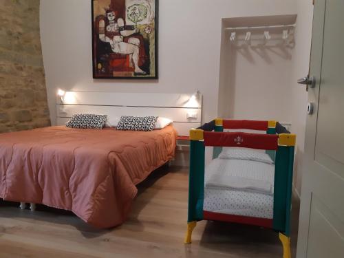 a bedroom with a bed with a chair next to it at 7centro in Lastra a Signa