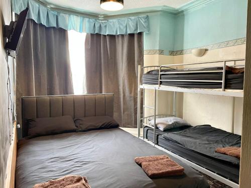 a room with two bunk beds and a window at Sam Residence Hotel in Blackpool