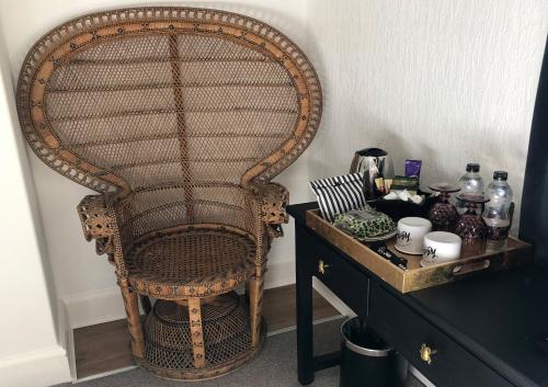 a wicker chair sitting next to a table at High Tor Guest House in Whitby
