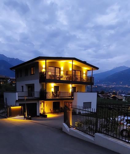 a building with lights on top of it at night at Marlingsuites - Vinea - Wieser Josef - Marling in Marlengo
