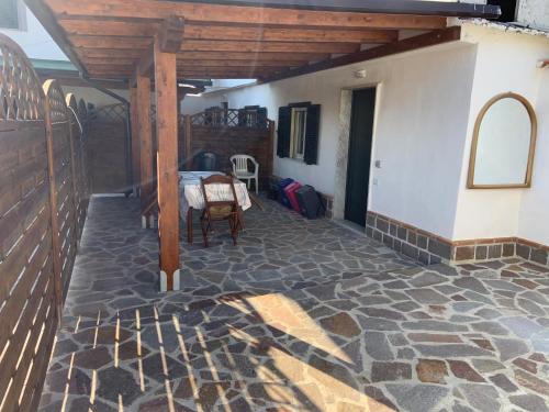 a porch of a house with a stone floor at Edoardo e Franca in Minturno
