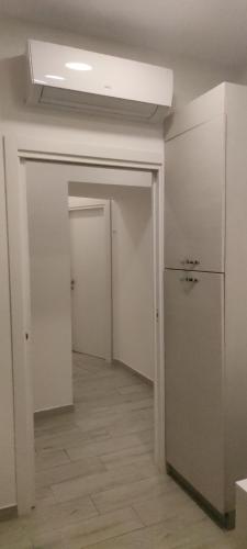 an empty room with a door and a refrigerator at Guest House Via Milano in Catanzaro