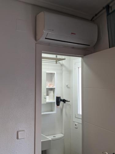 a bathroom with a sink and a toilet in a room at Estudio con Piscina, Playa y Wifi in Denia