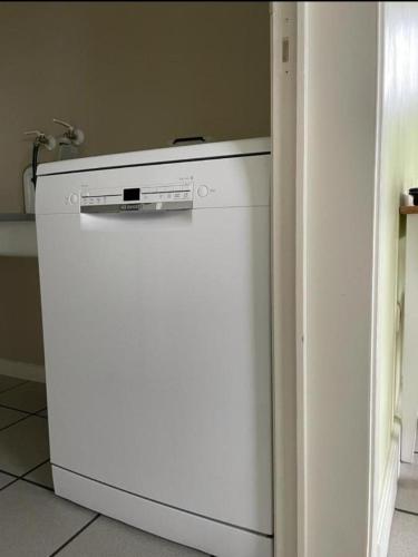 a white refrigerator in a kitchen next to a wall at Het Damhert in Kortenaken