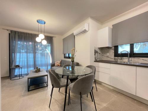 a kitchen and living room with a table and chairs at Athenean Modern Escape near Marina Flisvos in Athens