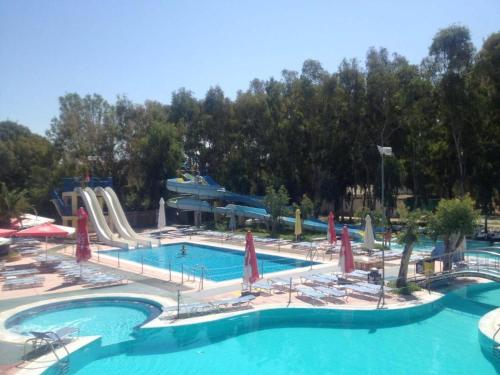 a large swimming pool with a water slide in a resort at Camping Golden Sunset in Alissos