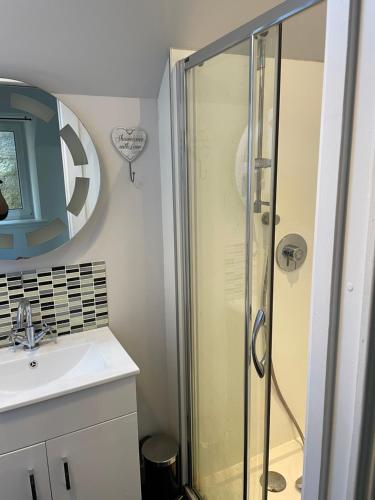 a bathroom with a shower and a sink at Newsagents Flat in Lairg