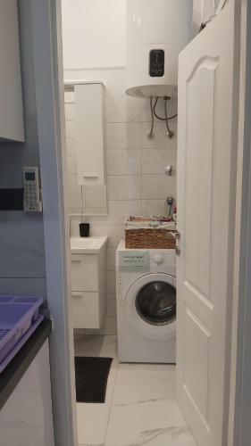 a small bathroom with a washing machine in it at Apartment Lavanda in Mali Lošinj