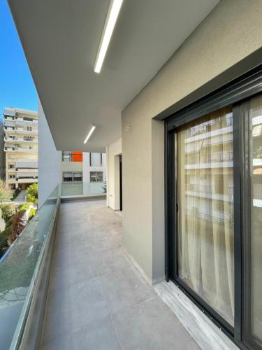 a balcony of a building with a large window at Athenean Modern Escape near Marina Flisvos in Athens
