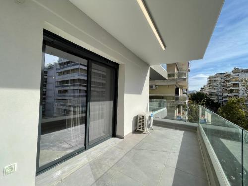 a balcony with a view of a building at Athenean Modern Escape near Marina Flisvos in Athens