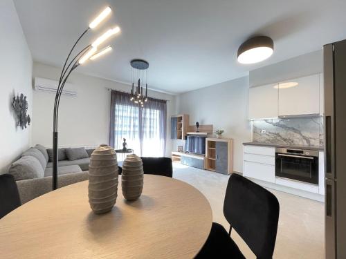 a kitchen and living room with a table and chairs at Athenean Modern Escape near Marina Flisvos in Athens