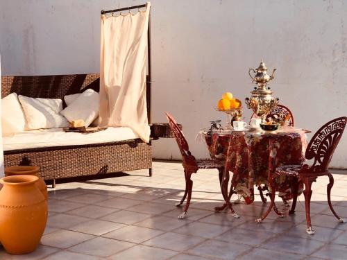 a dining room with a table and chairs and a bed at Captivating Studio Apartment in Mexilhoeira Grande in Mexilhoeira Grande