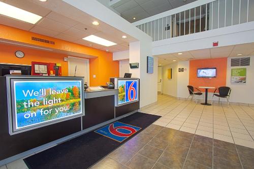 a waiting room with a large tv in a building at Motel 6-East Brunswick, NJ in East Brunswick