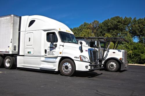 a white semi truck parked in a parking lot at Motel 6-East Brunswick, NJ in East Brunswick