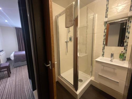 a bathroom with a shower and a sink at The Bell Guesthouse in Peterlee