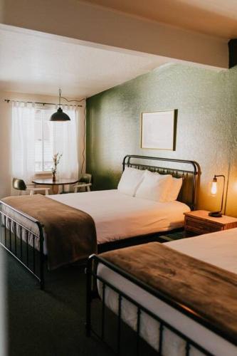 a hotel room with two beds and a window at The Long Barn Lodge in Long Barn