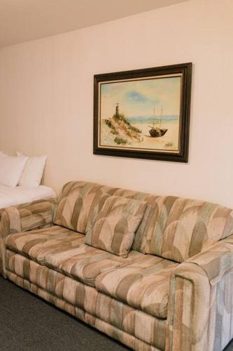 a couch in a room with a picture on the wall at The Long Barn Lodge in Long Barn