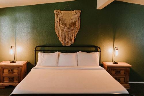 a bedroom with a bed with two nightstands and two lamps at The Long Barn Lodge in Long Barn