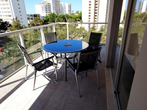a blue table and chairs on a balcony at Elite Residence Praia da Rocha in Portimão