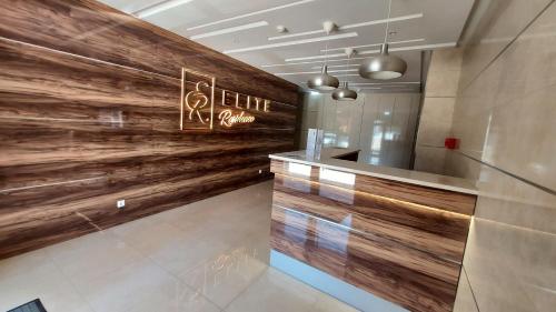 a lobby with a wooden wall in a building at Elite Residence Praia da Rocha in Portimão
