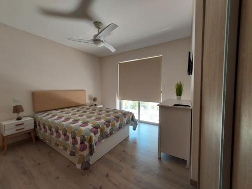 a bedroom with a bed and a ceiling fan at Elite Residence Praia da Rocha in Portimão