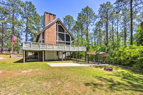 a brick house with a large yard with a playground at Brookeland Resort Cabin with Golf and Lake Access in Brookeland
