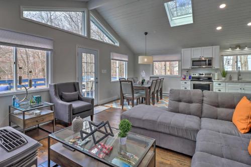 a living room with a couch and a table at 6 Mi to Camelback Slopes! Home with Game Room in Long Pond