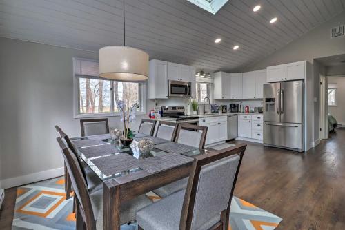 a kitchen with a table and chairs and a refrigerator at 6 Mi to Camelback Slopes! Home with Game Room in Long Pond
