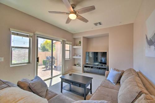 a living room with a couch and a ceiling fan at Goodyear Escape with Grill Community Pool Access! in Goodyear