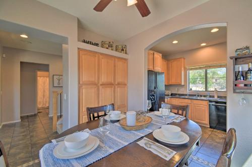 a kitchen with a wooden table and a dining room at Goodyear Escape with Grill Community Pool Access! in Goodyear