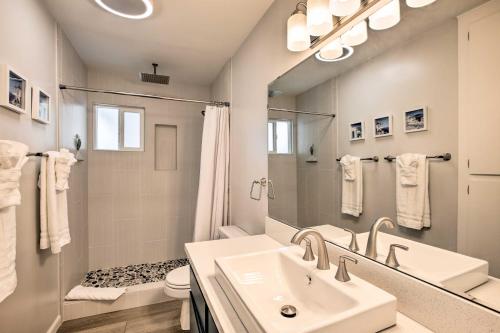 a white bathroom with a sink and a mirror at Spacious House with Yard in SLO Wine Country! in San Luis Obispo