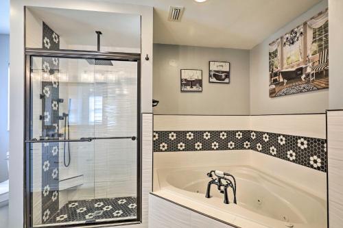 a bathroom with a tub and a shower and a sink at Lavish Holiday Home with Lanai and Heated Outdoor Pool in Holiday