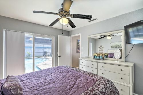 a bedroom with a purple bed and a ceiling fan at Lavish Holiday Home with Lanai and Heated Outdoor Pool in Holiday