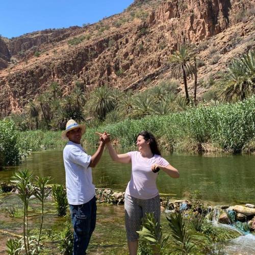 a man and a woman are holding their hands together at Oasis de Tiout in Tiout