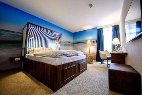 a bedroom with a large bed with blue walls at Dorint Hotel Alzey/Worms in Alzey