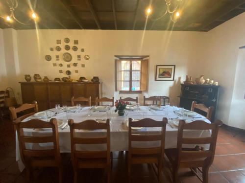 a large dining room with a white table and chairs at Hostal San Nicolas in Antigua Guatemala