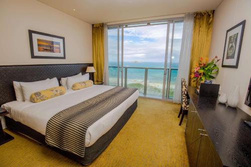 a hotel room with a bed and a large window at Grand Papua Hotel, a member of Radisson Individuals in Port Moresby
