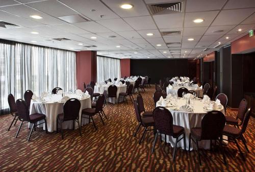a banquet room with tables and chairs with white tablecloths at Grand Papua Hotel, a member of Radisson Individuals in Port Moresby