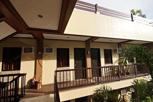 an outside view of a building with a balcony at Pacific Palm Suites Davao powered by Cocotel in Davao City
