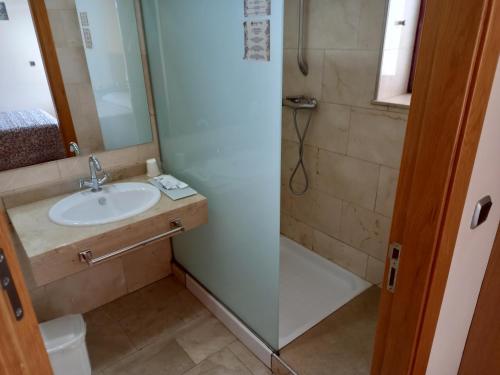 a bathroom with a sink, toilet and shower at Olimpia Hoteles in Totana
