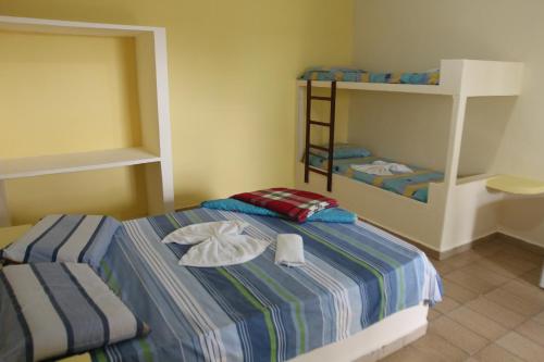 a bedroom with a bed and a bunk bed at Hotel Marina Clube de Pesca in Cananéia