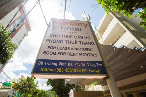 a sign for a hotel in front of a building at Mercury Hotel & Apartment in Vung Tau
